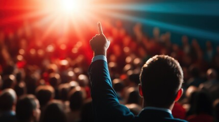 A dynamic image capturing an audience member raising a hand against a backdrop of bright stage lights, symbolizing engagement, excitement, and public participation in a performance.