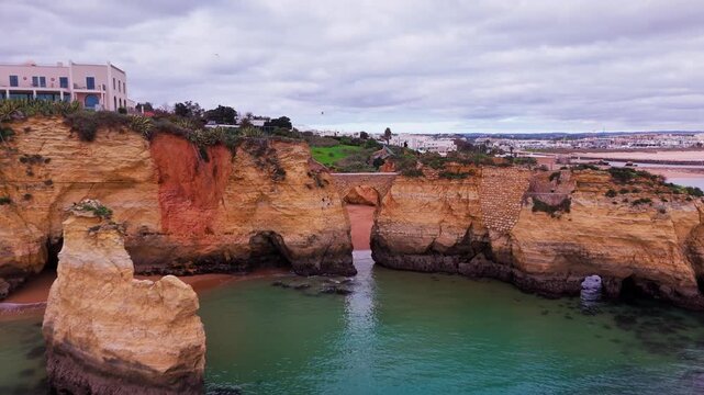 Aerial View of Ponte do Antigo Forte do Pinhao at Praia dos Estudantes in Lagos Algarve Portugal. 