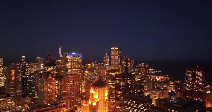 Aerial drone view of downtown Chicago skyline at night featuring illuminated skyscrapers and urban city lights in Illinois USA January 13, 2026