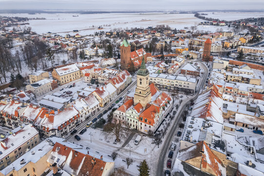 Drone aerial of Byczyna in winter, Poland. White-covered old town, medieval layout and peaceful snowy landscape.