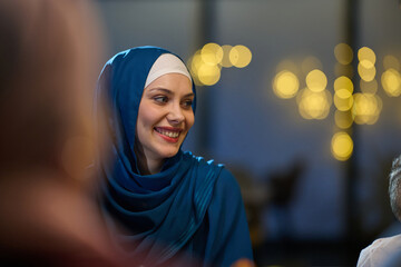 Happy Muslim Woman in Blue Hijab Smiling with Warm Bokeh Background