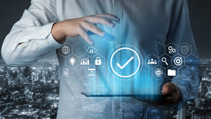 A businessman interacts with holographic technology on a tablet, surrounded by various digital icons, symbolizing innovation and data security in a vibrant urban landscape at night. Gantry