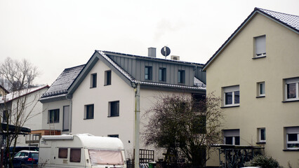 Winter landscape of European houses, blanketed in snow, capturing the beauty of cold season in a...
