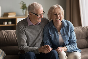Golden years of love. Warm romantic portrait joyful affectionate aged couple husband wife cuddle on...
