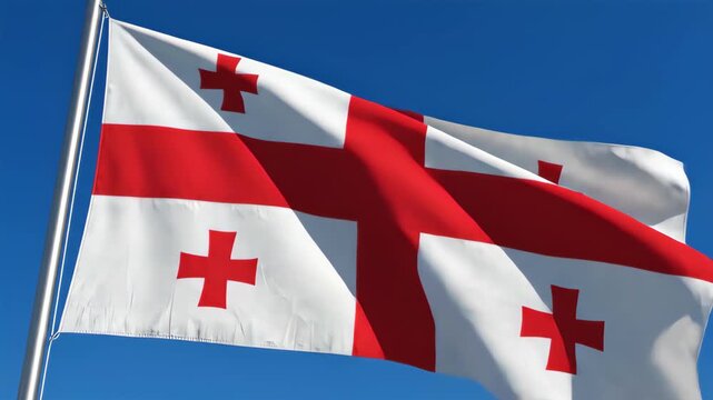 National flag of Georgia waving in the wind against a clear blue sky