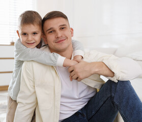 Fototapeta premium Portrait of father and his son at home
