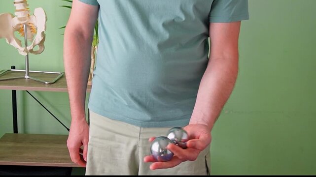 Man Rolling Chinese Baoding Balls in Hand