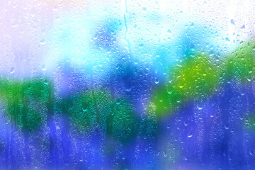 Window glass with rain drops and drips, closeup