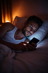 Fototapeta premium Man reading smartphone messages while lying on pillow. Concept of mobile communication, messaging apps, digital interaction, real time connectivity, smartphone technology, online services.
