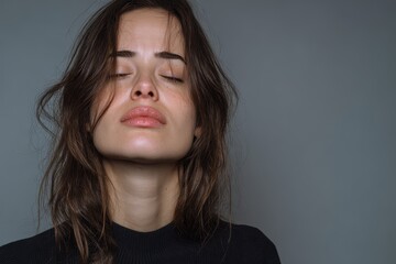 A rejected distressed young woman faces difficulties biting her lip and shutting her eyes in despair