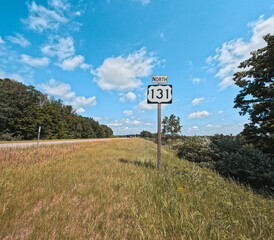 Michigan State Highway 131 (M-131) North Interstate sign situated on the right side of the road with room for copy space. M-131 serves as a transportation route from southern MI up through Petoskey.