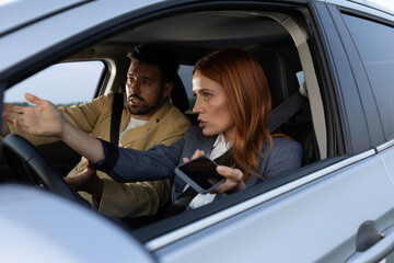 Couple arguing while sitting in a car about something on road