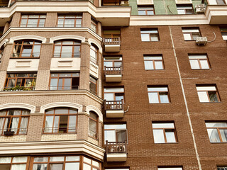 Elegant Urban Building Exterior, Modern City Residence With Decorative Features, Sophisticated City Apartment Complex Showcasing Ornate Brickwork And Scenic Cityscape Backdrop