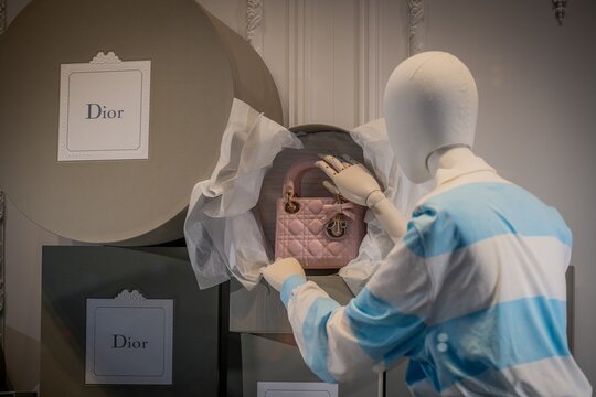 Milan, Italy - 2026, 13 Jan: Elegant Dior FW25 display featuring a pink designer handbag, stylish packaging, and chic boutique ambiance for luxury fashion inspiration