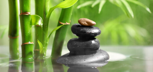 Lake with stack of spa stones and bamboo in tropical garden