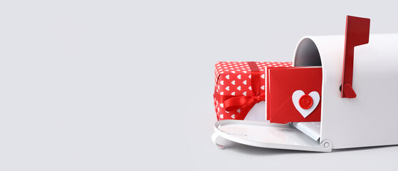 Mailbox with letters and gift on light background. Valentine's Day celebration
