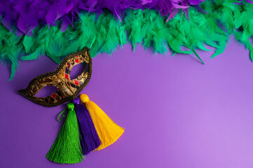 Vibrant Mardi Gras background with mask, beads, and festive decorations