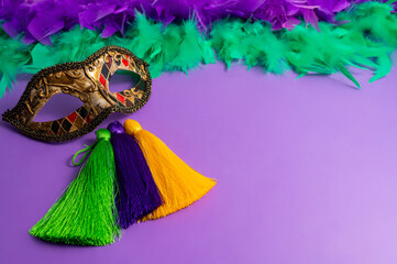 Vibrant Mardi Gras background with mask, beads, and festive decorations
