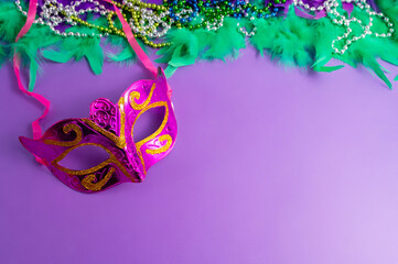 Vibrant Mardi Gras background with mask, beads, and festive decorations