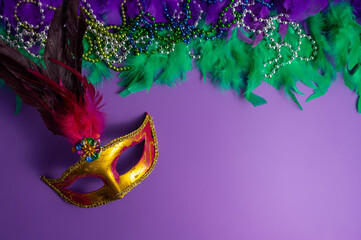 Vibrant Mardi Gras background with mask, beads, and festive decorations