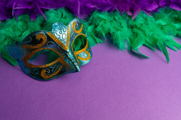Vibrant Mardi Gras background with mask, beads, and festive decorations
