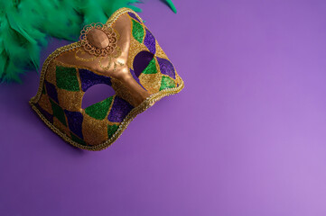 Vibrant Mardi Gras background with mask, beads, and festive decorations