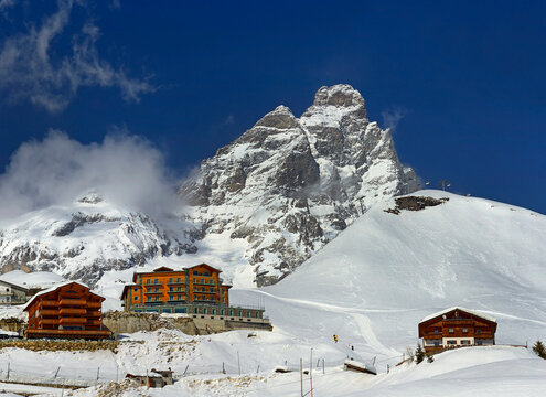 Scenic view on Matterhorn peak - Monte Cervino from Breuil-Cervinia. Mountain situated on the border between Switzerland and Italy, over the Swiss Zermatt and the Italian town of Breuil-Cervinia.