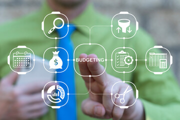 Business person using virtual touch screen presses the text BUDGETING. Budgeting Business concept. Budget Planning Financing Control Management.