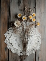 Rustic flat-lay of dried flowers and lace doilies on an aged wooden table, soft lighting