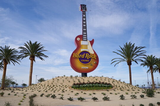 Hard Rock Cafe Tejon guitar sign with palm trees against a clear blue sky in Tejon, California, January 2, 2026.
