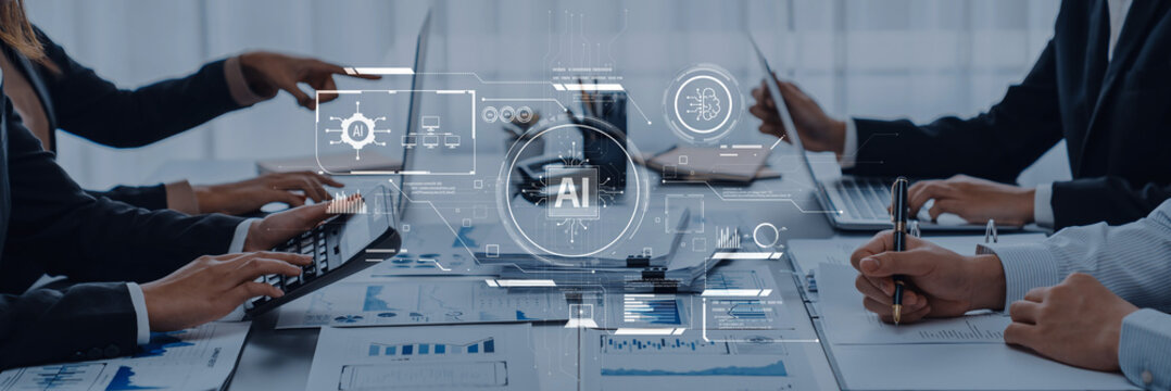 A modern business meeting showcasing collaboration among professionals, emphasizing technology and artificial intelligence in data analysis and visualization processes. Trope - Powered by Adobe