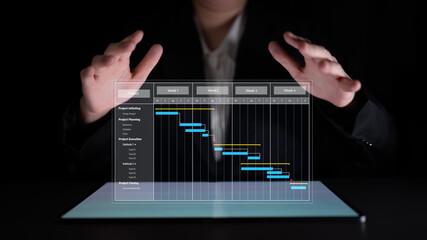 A business professional interacts with a digital Gantt chart displayed on a tablet, illustrating project planning and management in a modern office environment. Tessel