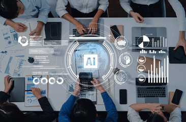 A top-down view of professionals engaged in a collaborative data analysis session, showcasing artificial intelligence concepts with multiple devices on a modern office table. Trope