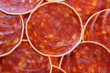 Seamless chorizo slices pattern ideal for packaging and textile design, repeating circular cured...