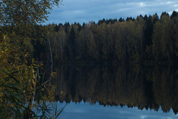beautiful lake with forested shores in the October day