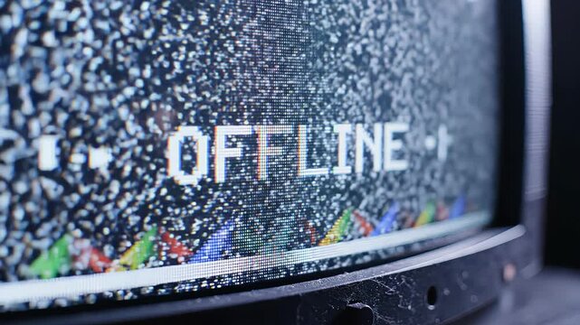 Close up view of an old cathode ray tube monitor showing a pixelated offline message, with signal interference, static noise, and flickering effects creating a retro technological aesthetic