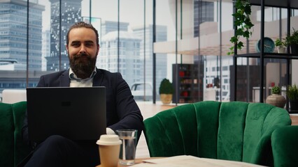 Goals oriented businessman focuses on his company and career development, analyzing reports and trends to ensure a success story in the competitive environment of business industry. Camera A.