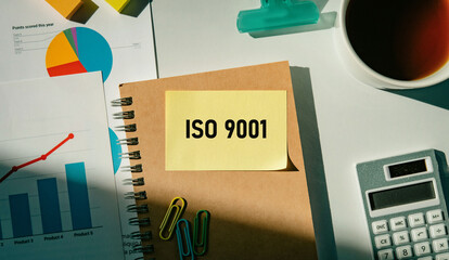 There is sticky note with the word ISO 9001. It is as an eye-catching image.