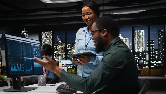 African american coworkers doing high five after successful collaboration, working together for a business mission. Teamwork with unity and support for cheerful people, winning. - Powered by Adobe