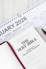 Christian holy bible book with January 2026 calendar. Top view. Scripture study time, annual goals,...