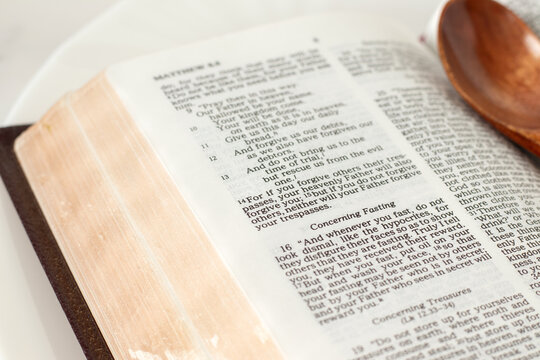 Christian text for fasting in open holy bible book. Close-up. Biblical concept.
