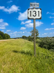 Michigan State Highway 131 (M-131) North Interstate sign situated on the right side of the road with room for copy space. M-131 serves as a transportation route from southern MI up through Petoskey.