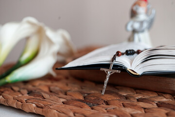 Book with cross and angel figurine on mat