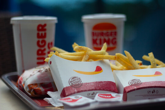 Batumi, Georgia - June 27, 2025: Horizontal photo. French fries, paper cup with Coca-Cola lemonade, on tray on table of fast food cafe Burger King. Concept of lunch, eat, soda water, soft drink, order