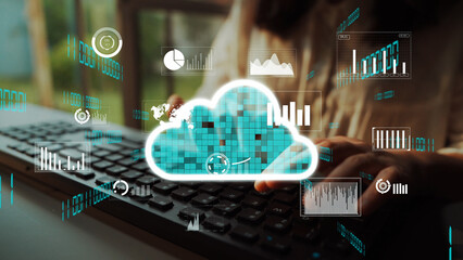 A modern workspace featuring a cloud computing concept, showcasing data visualization elements and user interaction with a keyboard, emphasizing technology and innovation. Xenic