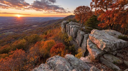 Dramatic overlook showcases vibrant autumn foliage at sunset over rolling distant landscape