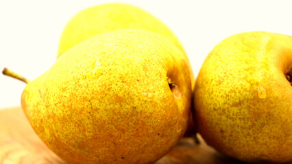Close-up of fresh yellow pears with water droplets