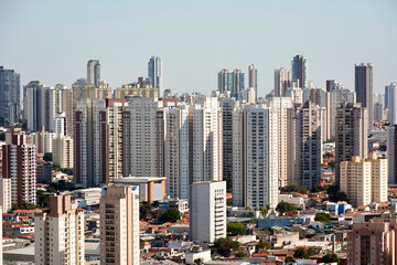 Naklejka premium Cityscape of the city of Sao Paulo with skyscrapers, residential buildings and houses in the Tatuape and Carrao neighborhoods.