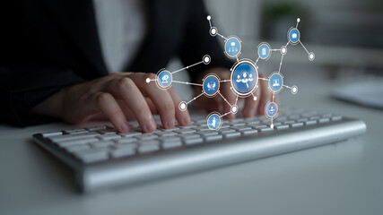 A close-up image of hands typing on a sleek silver keyboard, complemented by digital icons representing various concepts in technology, business, and data connectivity. Tessel