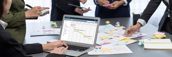 Analyst team use sticky note for creative and analytic brainstorm for business idea with BI data dashboard on laptop screen. Analysis financial data visualization tech for marketing strategy. Prodigy